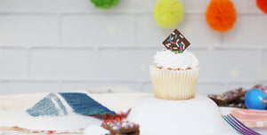 vanilla cupcake with sprinkle dreams chocolate square as garnish