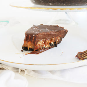 chocolate caramel pie on a plate with a bite taken