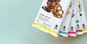 five chuao chocolate bars showing the fair trade certified logo on each