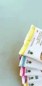 five chuao chocolate bars over a teal background showing fair trade certified logo