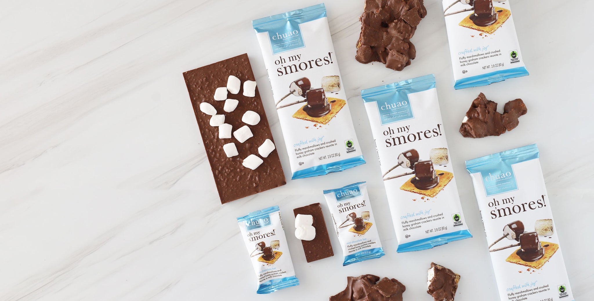 Oh My S'mores chocolate bars and bark luxe with marshmallows on a white surface