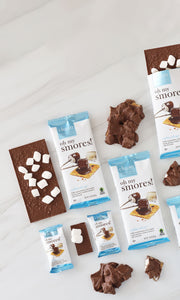 Oh My S'mores chocolate bars and bark luxe with marshmallows on a white surface