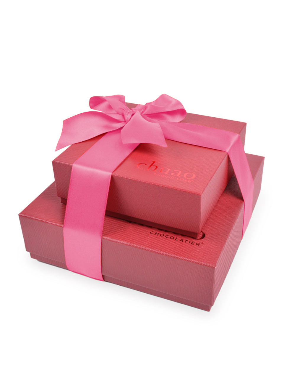 2 red chuao chocolatier gift boxes stacked and tied with a pink ribbon