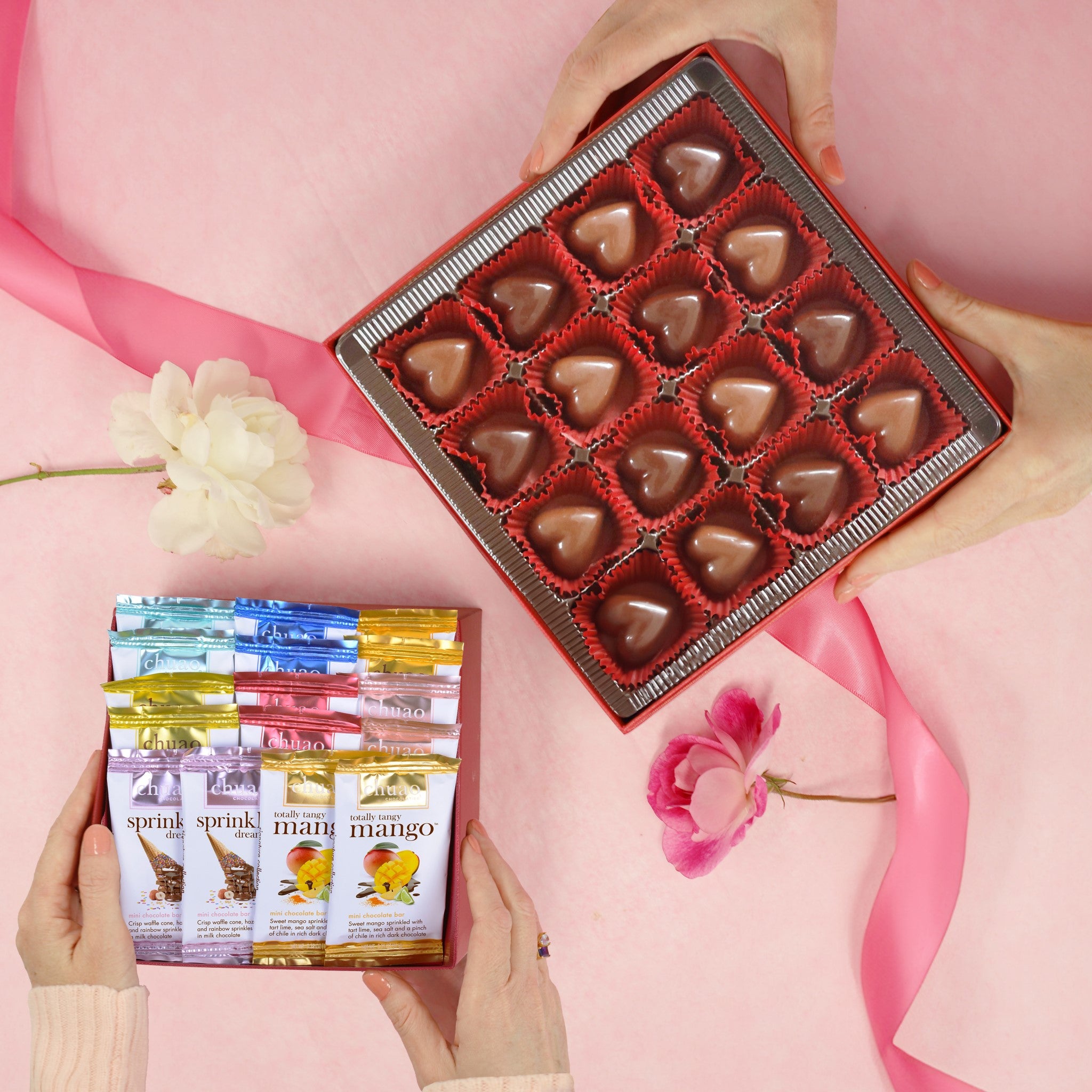 16 piece passionate hearts bonbons in a red tray over a pink background and ribbon with a 16 piece mini bar set