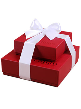 two red chuao gift boxes stacked on one another tied with a white ribbon